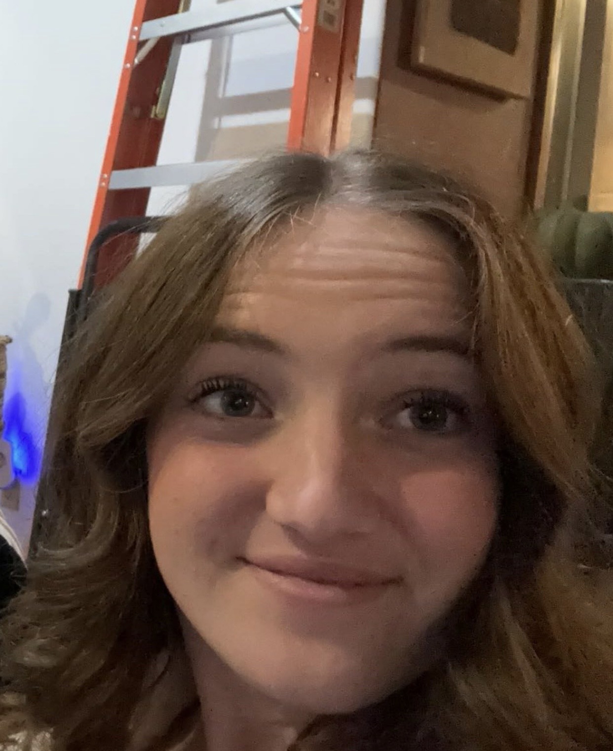 Woman with light brown hair smiles into camera.